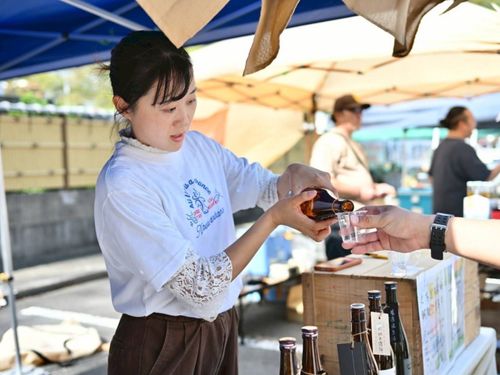 イベント会場で来場者に飲み物を提供する蛭田結衣さん