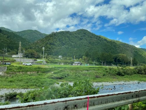車窓から見える山と安曇川。鮎釣りを楽しむ釣り人の姿も