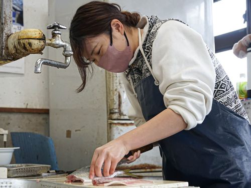 武宮鮮魚店で魚捌きをする様子（株式会社まちの灯台阿久根）